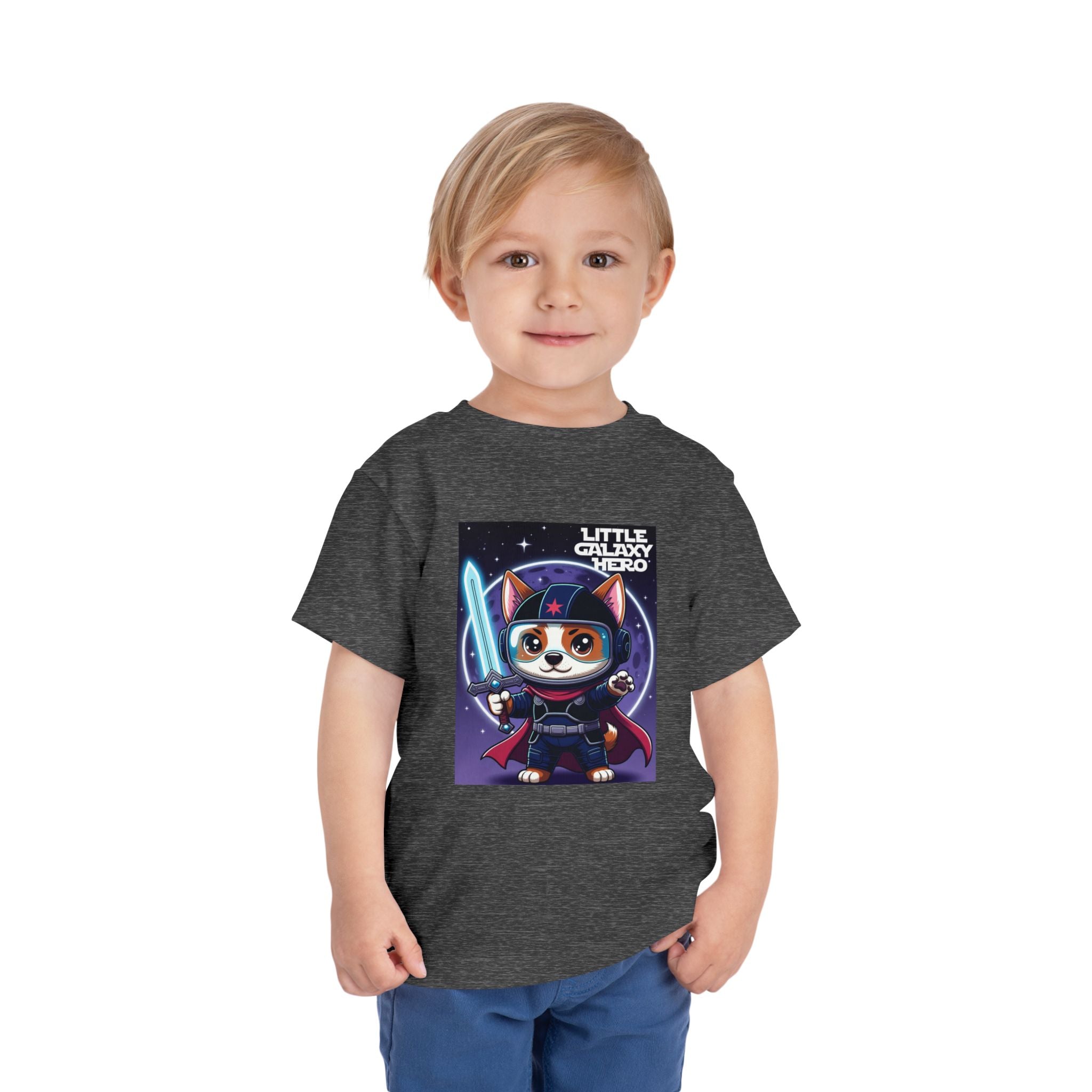 Little Galaxy Hero kids t-shirt featuring a cartoon space puppy with a lightsaber on a dark gray background.