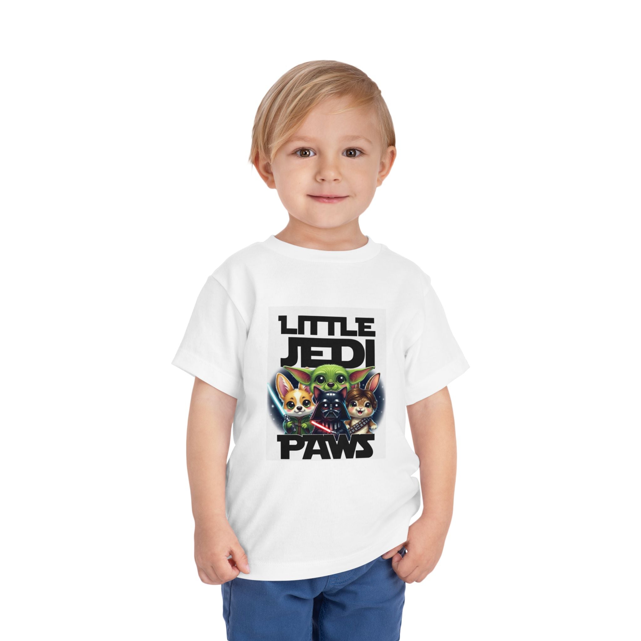 Toddler wearing a white tee featuring Yoda, Vader, and Chewbacca with the text "Little Jedi Paws.