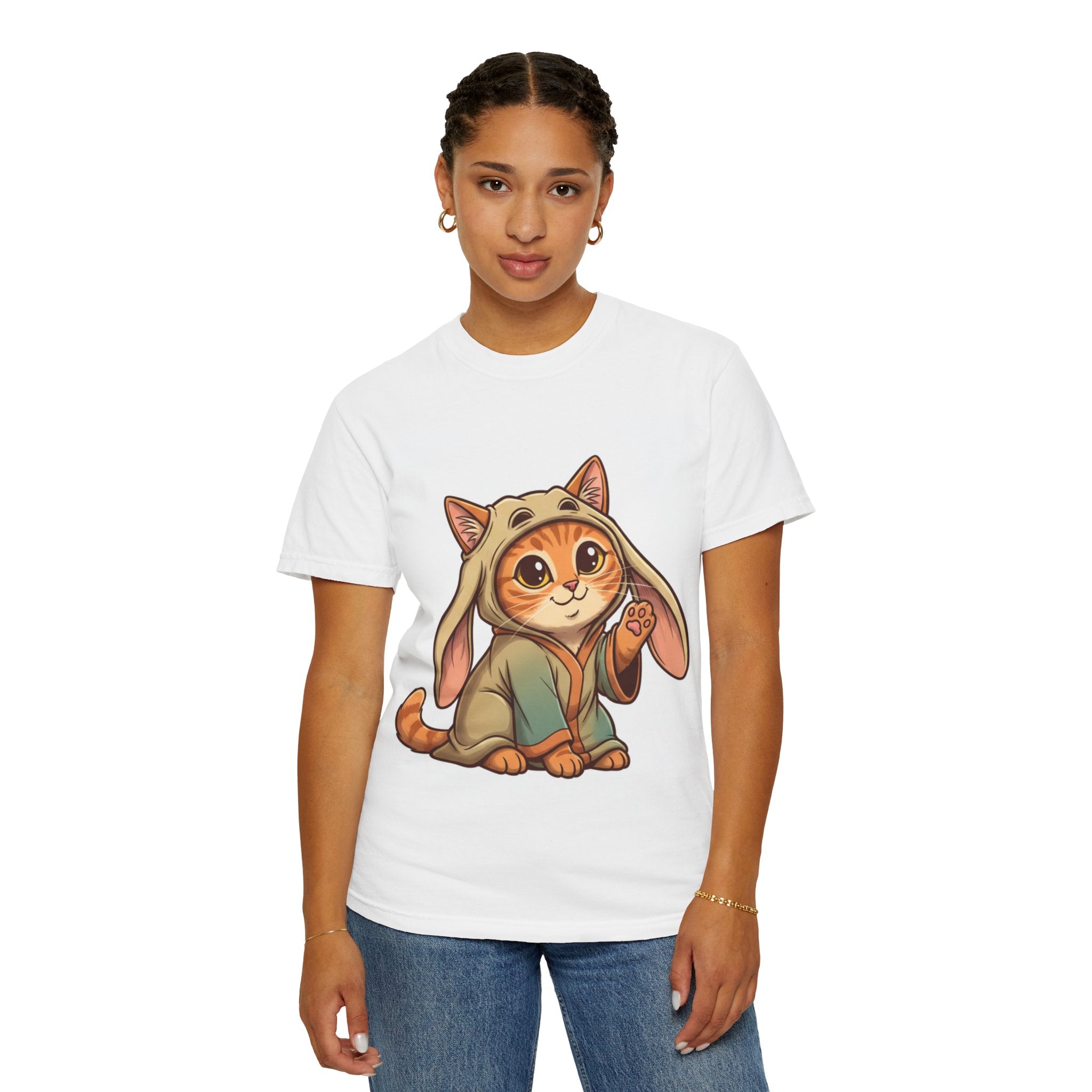 White t-shirt featuring an orange tabby cat in a bunny hoodie, with large expressive eyes and a playful pose.