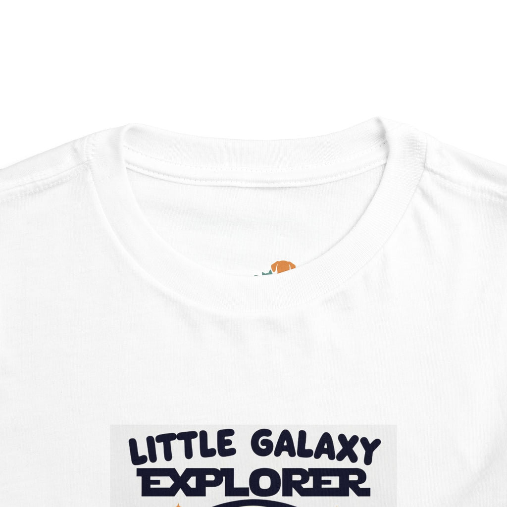 White kids' t-shirt featuring "Little Galaxy Explorer" text in bold navy letters, with a round neckline and short sleeves.