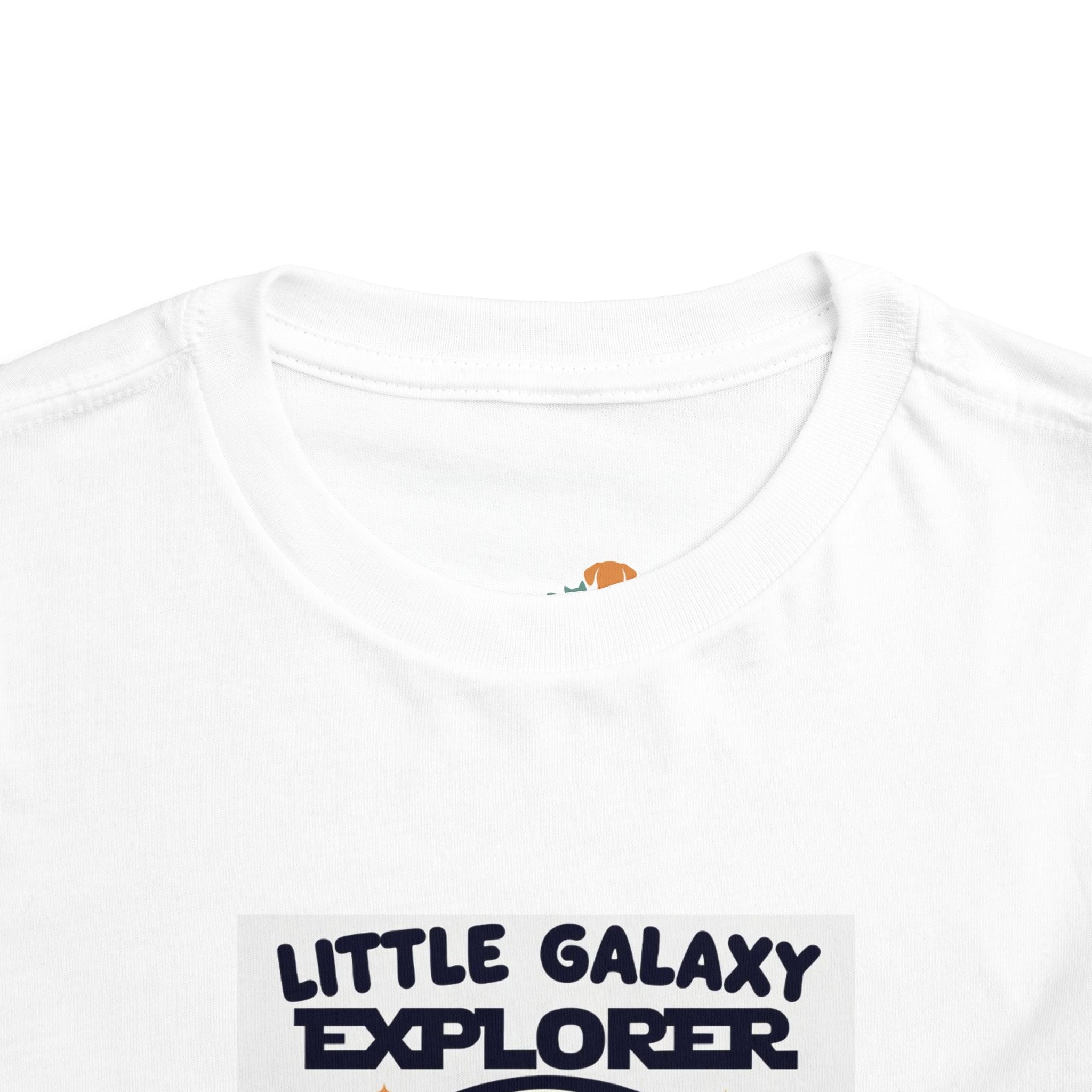 White kids' t-shirt featuring "Little Galaxy Explorer" text in bold navy letters, with a round neckline and short sleeves.