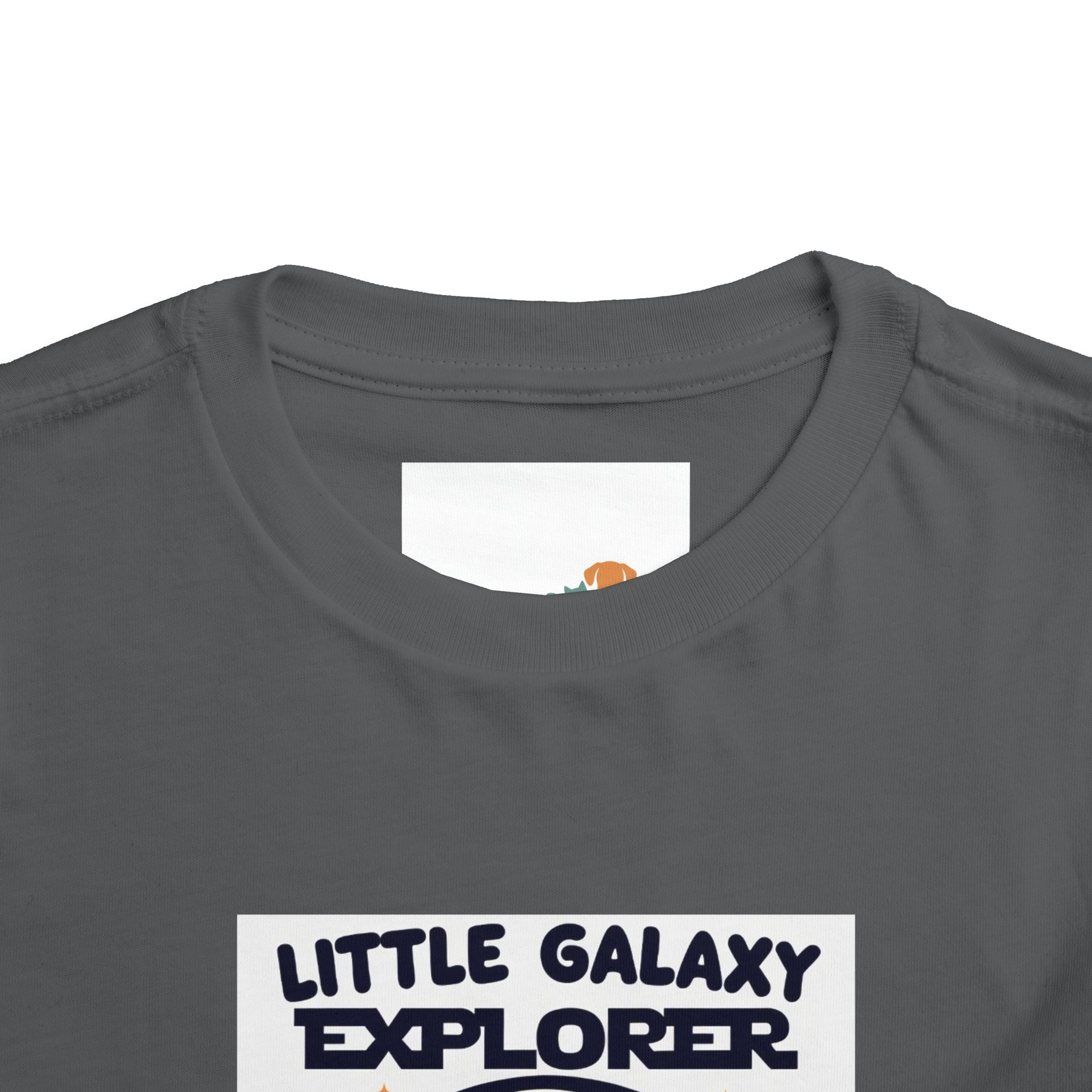 Gray kids' t-shirt featuring "Little Galaxy Explorer" text and a colorful space-themed graphic on the front.
