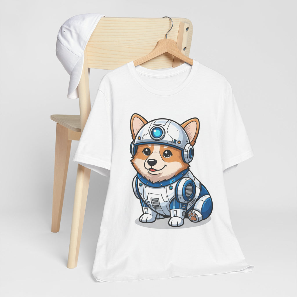 Corgi wearing an R2-D2 costume on a white t-shirt, displayed on a wooden hanger with a cap nearby.