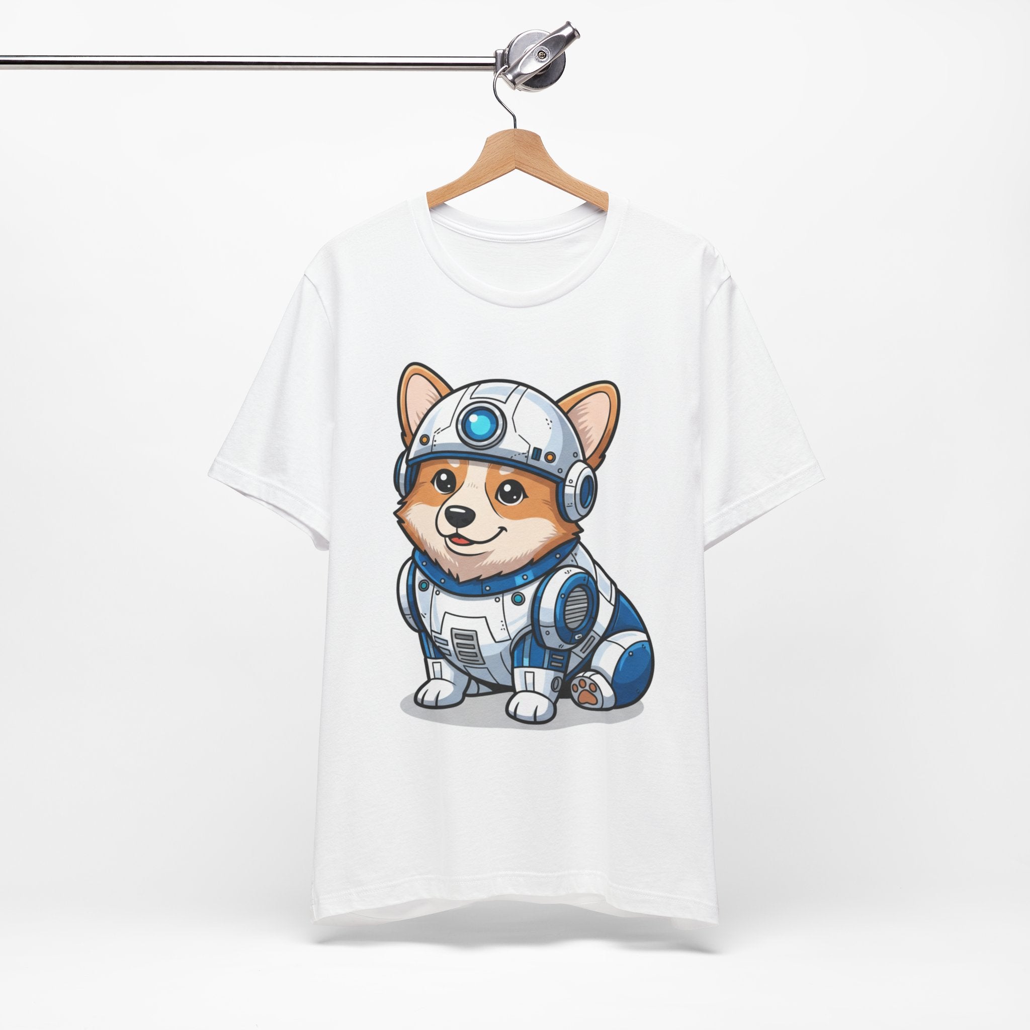 Corgi wearing an R2-D2 costume on a white t-shirt, displayed on a wooden hanger against a plain background.