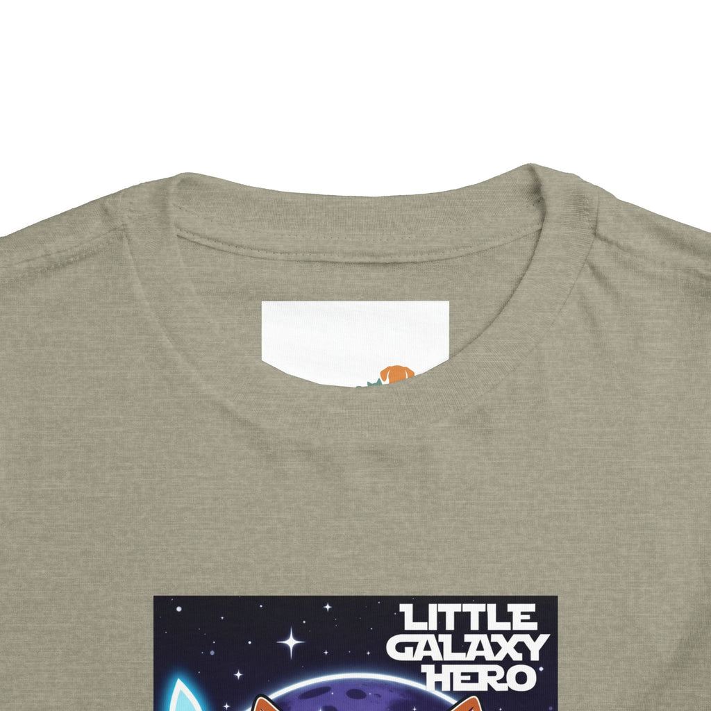 Light gray kids t-shirt featuring a cartoon space puppy and the text "Little Galaxy Hero" in colorful lettering.