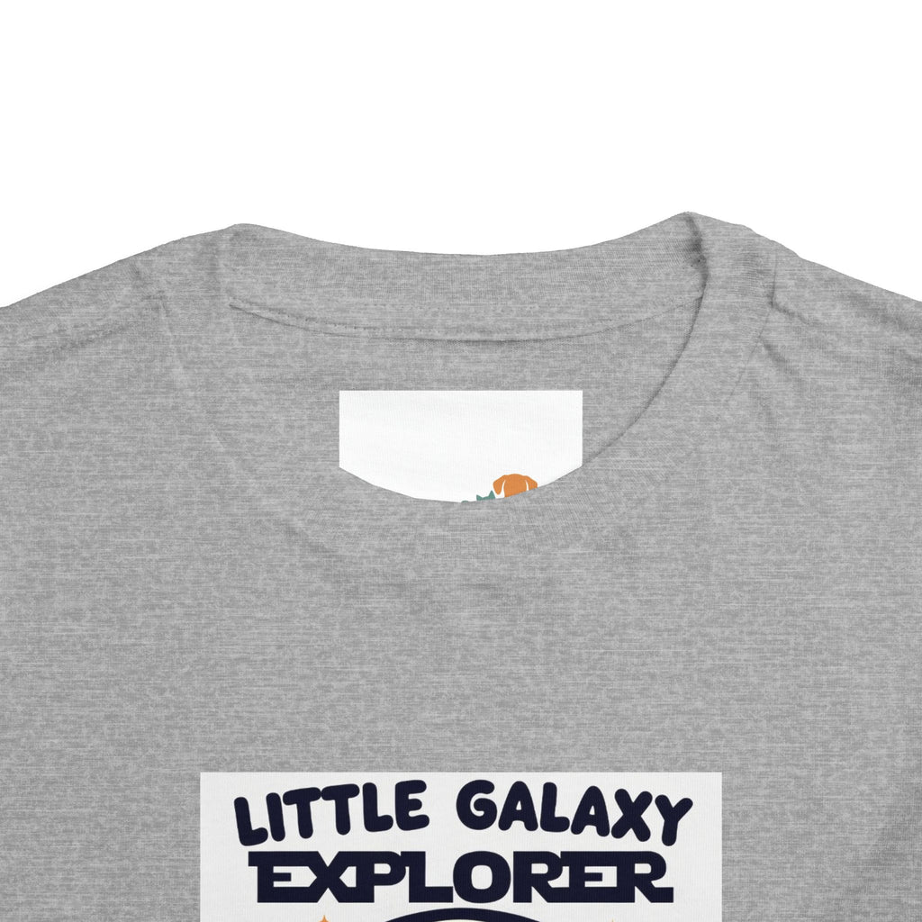 Gray kids' t-shirt featuring "Little Galaxy Explorer" text in navy blue, designed for space-themed adventures.