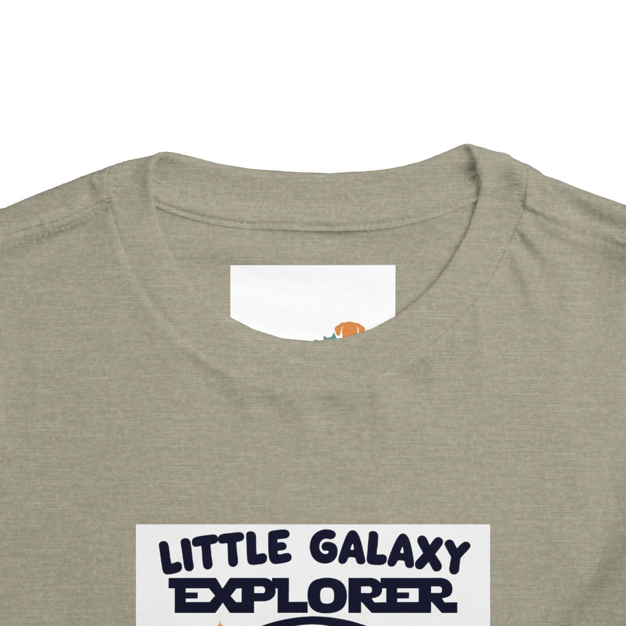 Light gray kids' t-shirt featuring "Little Galaxy Explorer" text in navy blue, with a round neckline and short sleeves.