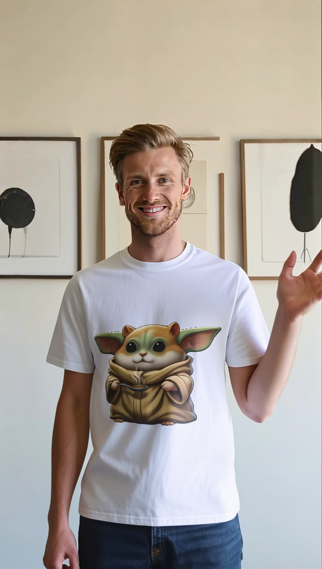 White T-shirt featuring a cartoon hamster in a space suit, worn by a smiling man against a minimalist background.