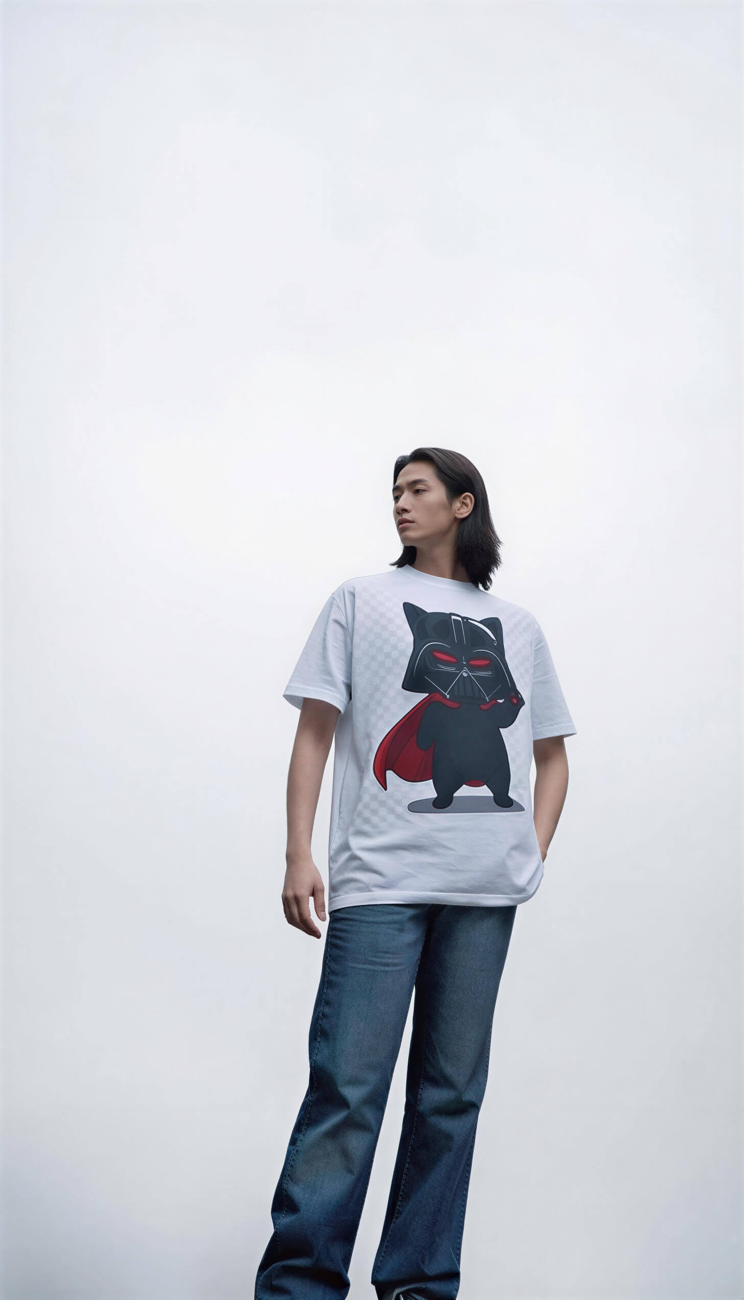 Darth Vader cat graphic t-shirt featuring a black cat in a red cape, worn by a person against a plain background.