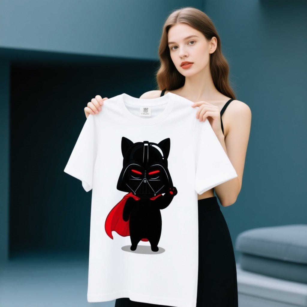 Darth Vader cat graphic t-shirt featuring a black cat in a cape, holding a lightsaber, on a white background.